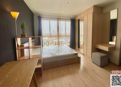 Bright and spacious bedroom with large window and city view
