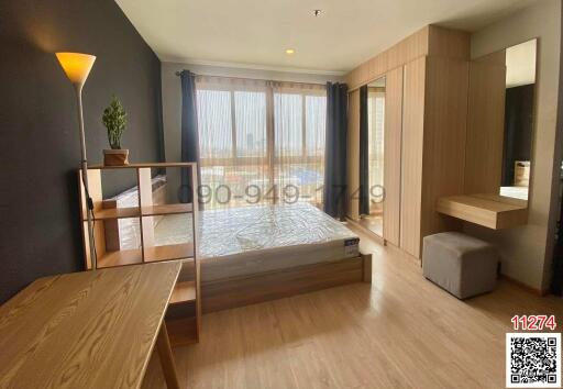 Bright and spacious bedroom with large window and city view