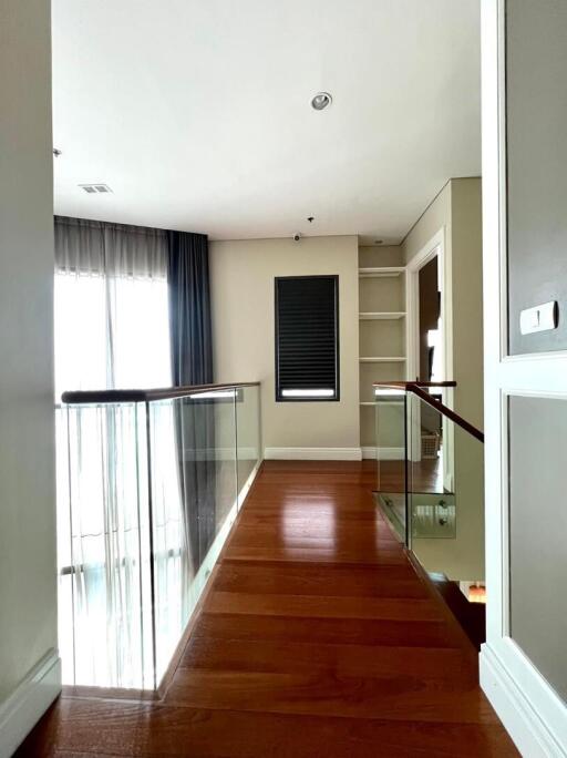 Modern hallway interior with wooden flooring and natural light