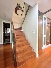 Wooden staircase with glass balustrade in a modern home interior