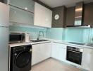 Modern kitchen with fully fitted appliances and ceramic flooring