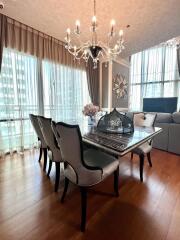 Elegant dining room with chandelier and large windows