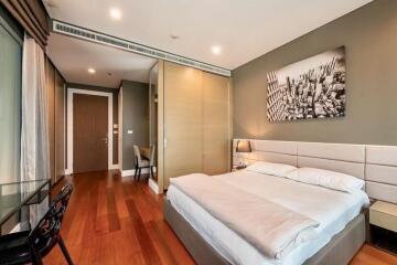 Modern bedroom with wooden floor and contemporary art