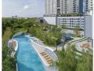 Luxurious outdoor pool with lush greenery and lounging areas in a modern apartment complex