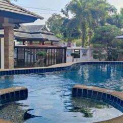 Residential swimming pool with an adjoining house