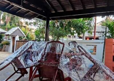 Covered outdoor patio with furniture and protective plastic sheeting