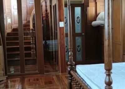 Elegant wooden bedroom interior with reflections on hardwood floor