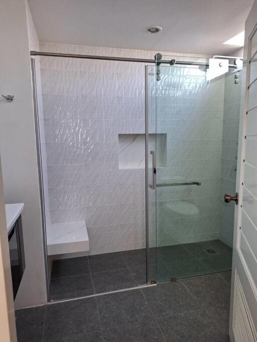 Modern bathroom with a glass shower and white tiles