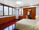 Spacious bedroom with city view and hardwood floors