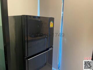 Modern kitchen with black refrigerator and ambient blue lighting