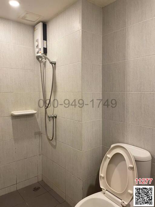 Modern bathroom with wall-mounted shower and toilet