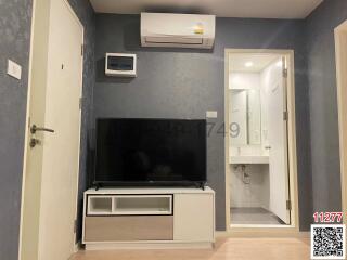 Modern bedroom with wall-mounted TV and en suite bathroom