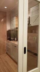 Modern kitchen with wooden cabinets and glass door