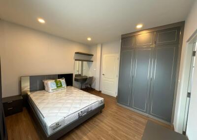 Spacious bedroom with queen-sized bed and built-in wardrobes