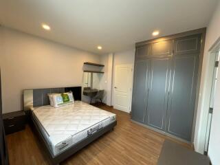 Spacious bedroom with queen-sized bed and built-in wardrobes