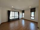 Spacious living room with hardwood floors and ample natural light