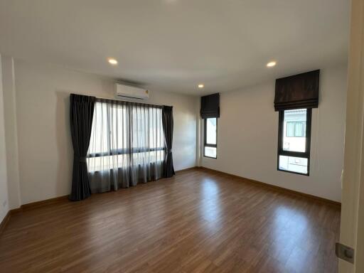 Spacious living room with hardwood floors and ample natural light