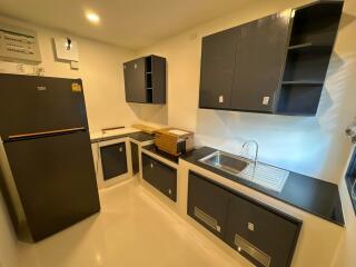 Modern kitchen with black appliances and cabinetry