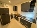 Modern kitchen with black appliances and cabinetry