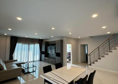 Modern living room with dining area and staircase