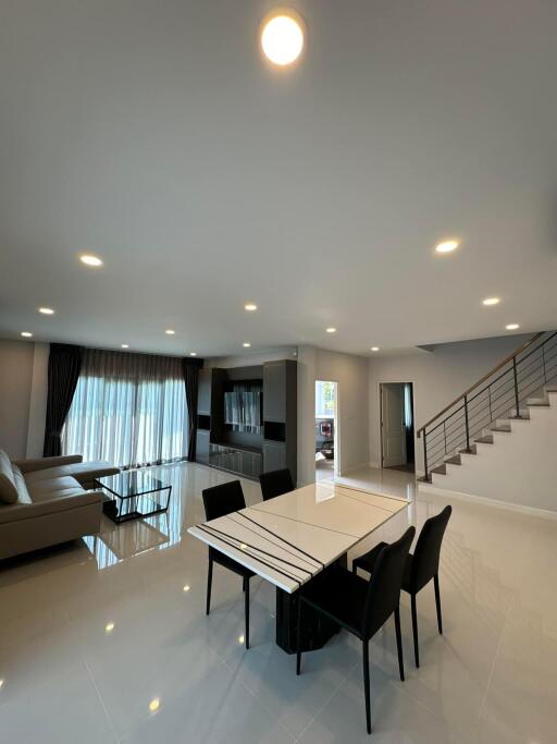 Modern living room with dining area and staircase