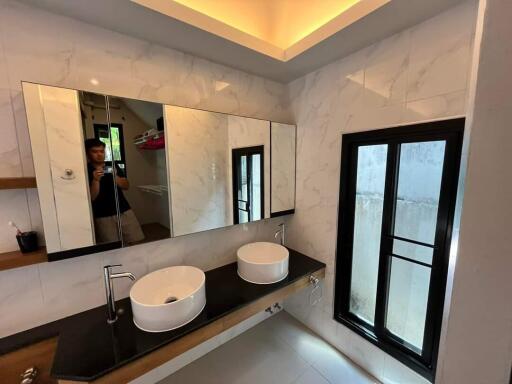 Modern bathroom with double sink and large mirror