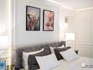 Elegantly decorated modern bedroom with framed wall art and plush bedding