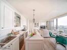 Modern kitchen with white cabinetry and marble countertops