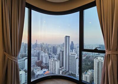 Modern living room with panoramic city view through large bay window