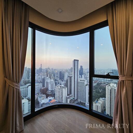 Modern living room with panoramic city view through large bay window