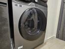 Modern front-loading washing machine in a tidy laundry area