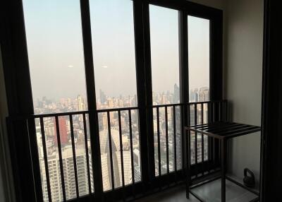 High-rise apartment interior with city view through large windows