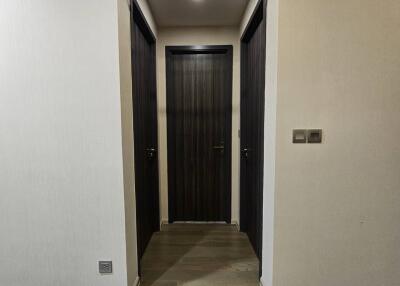 Modern hallway with sliding door and wooden floors