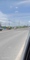 Urban road scene with clear skies and sparse traffic