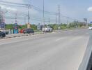 Urban road scene with clear skies and sparse traffic