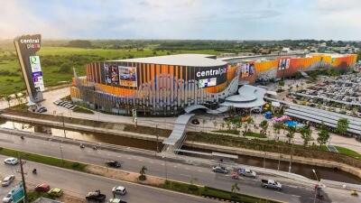 Aerial view of a large commercial shopping complex with extensive parking