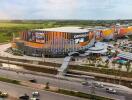 Aerial view of a large commercial shopping complex with extensive parking