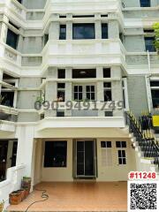 Front view of a multi-story residential building with balconies