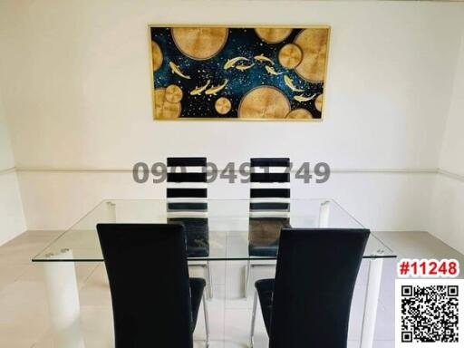 Modern dining room with glass table and contemporary art