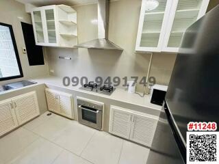 Modern kitchen with stainless steel appliances and white cabinets