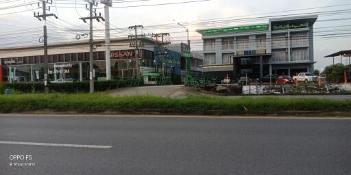 Street view of commercial buildings including car dealership