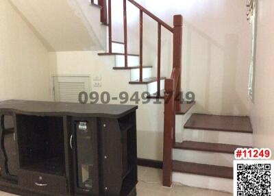 Interior staircase with storage unit and tiled flooring