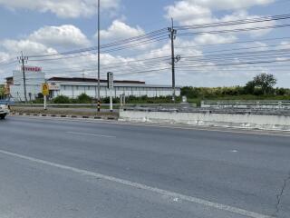 Exterior view of a property beside a roadway with clear skies