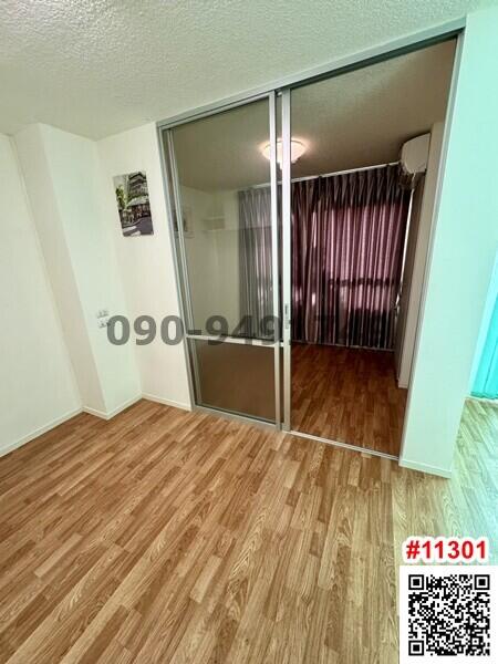 Cozy bedroom with mirrored closet doors and hardwood flooring