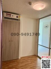 Compact bedroom with built-in wardrobe and air conditioning unit