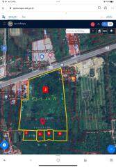 Aerial view of a land plot with demarcations and surrounding roadways