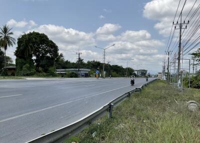 Suburban road with electrical lines and sparse traffic