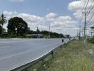 Suburban road with electrical lines and sparse traffic