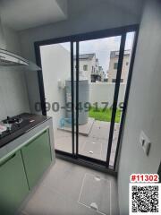 Modern kitchen with large window leading to the yard