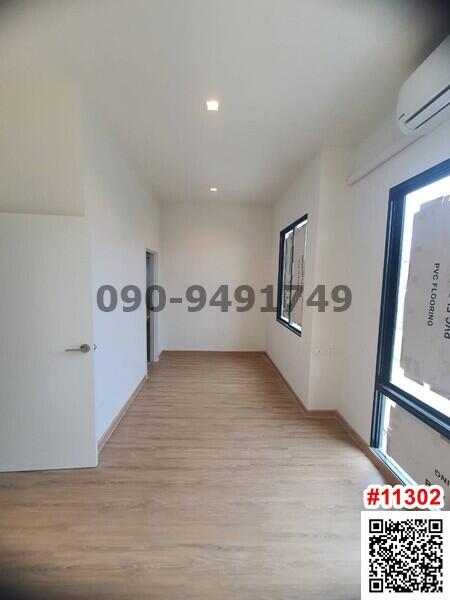 Modern hallway interior with wooden flooring and ample natural light